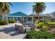 Outdoor patio area with comfortable seating, lush landscaping, and views of the surrounding community at 7015 Stanhope Pl, University Park, FL 34201