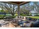 Covered patio with comfortable seating overlooking a scenic lake and golf course at 7015 Stanhope Pl, University Park, FL 34201
