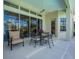 Inviting patio with comfortable seating and a ceiling fan, perfect for outdoor relaxation and entertaining at 7015 Stanhope Pl, University Park, FL 34201