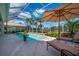 Relaxing screened pool and outdoor lounge area with comfortable chaise lounges at 7015 Stanhope Pl, University Park, FL 34201