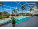 Inviting screened pool and jacuzzi in a beautiful outdoor oasis at 7015 Stanhope Pl, University Park, FL 34201