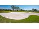 Golf course with sand trap hazards surrounded by well-maintained green at 7015 Stanhope Pl, University Park, FL 34201