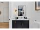 Modern powder room featuring a black vanity, white quartz countertop, and elegant sconce lighting at 7024 Brier Creek Ct, Lakewood Ranch, FL 34202