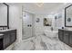 This spacious bathroom features marble floors, dual vanities, a soaking tub, and a frameless glass shower at 7024 Brier Creek Ct, Lakewood Ranch, FL 34202