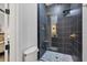 Elegant bathroom featuring a sleek glass-enclosed shower with dark tiles and a marble mosaic floor at 7024 Brier Creek Ct, Lakewood Ranch, FL 34202