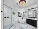 Bright bathroom showcasing a freestanding tub, glass shower, and elegant chandelier lighting at 7024 Brier Creek Ct, Lakewood Ranch, FL 34202
