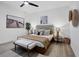 Bright bedroom features wood floors, ceiling fan, upholstered headboard, and neutral decor at 7024 Brier Creek Ct, Lakewood Ranch, FL 34202