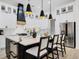Modern kitchen with a large island, white cabinetry, stainless steel appliances, and pendant lighting at 7024 Brier Creek Ct, Lakewood Ranch, FL 34202