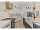 A modern kitchen with stainless steel appliances, white cabinets, and a large island at 7024 Brier Creek Ct, Lakewood Ranch, FL 34202