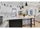 A modern kitchen with stainless steel appliances, white cabinets, and a large island at 7024 Brier Creek Ct, Lakewood Ranch, FL 34202
