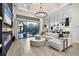 Open-concept living room with a fireplace, large sliding glass doors, and modern furnishings at 7024 Brier Creek Ct, Lakewood Ranch, FL 34202