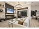 Inviting living room with fireplace, TV, modern decor, and seamless indoor-outdoor living at 7024 Brier Creek Ct, Lakewood Ranch, FL 34202
