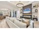 Bright living room featuring a fireplace, wall decor, modern furniture, and an open floor plan at 7024 Brier Creek Ct, Lakewood Ranch, FL 34202