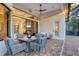 Charming outdoor dining area with a ceiling fan and access to both the indoor living space and pool area at 7024 Brier Creek Ct, Lakewood Ranch, FL 34202