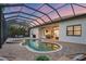 Screened-in pool area with an in-ground spa and outdoor seating, perfect for relaxation and entertainment at 7024 Brier Creek Ct, Lakewood Ranch, FL 34202
