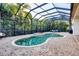 Inviting screened-in pool and spa area surrounded by lush tropical landscaping at 7024 Brier Creek Ct, Lakewood Ranch, FL 34202