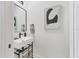 This powder room features a modern sink and mirror at 7024 Brier Creek Ct, Lakewood Ranch, FL 34202
