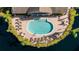 Bird's-eye view of the community pool featuring clear blue water, lounge chairs, and meticulous landscaping at 8043 St Simons St, Bradenton, FL 34201