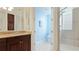 Bright bathroom with blue walls, tile flooring, and a tiled glass enclosed walk in shower at 8043 St Simons St, Bradenton, FL 34201