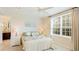 Serene bedroom with a ceiling fan, a window with blinds, and a neutral color scheme at 8043 St Simons St, Bradenton, FL 34201