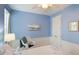 Coastal bedroom with blue walls, white trim, ceiling fan, and coordinated bedding at 8043 St Simons St, Bradenton, FL 34201