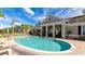 Community pool with shallow steps, surrounded by patio seating and a view of nearby townhomes at 8043 St Simons St, Bradenton, FL 34201