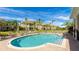 Community pool features shallow steps and is surrounded by lounge chairs and townhomes at 8043 St Simons St, Bradenton, FL 34201