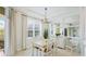 Cozy dining area with natural light, a modern chandelier, and a mirrored wall at 8043 St Simons St, Bradenton, FL 34201