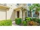 Inviting entryway with a brick path, lush shrubs, and covered porch at 8043 St Simons St, Bradenton, FL 34201