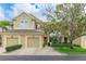 Charming townhouse featuring a tan facade, two-car garage, and manicured landscaping at 8043 St Simons St, Bradenton, FL 34201