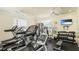 Bright gym featuring treadmills, weight machines, free weights, and a wall-mounted TV for entertainment at 8043 St Simons St, Bradenton, FL 34201