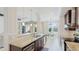 Bright, open kitchen featuring granite countertops, stainless steel appliances, and an island with a breakfast bar at 8043 St Simons St, Bradenton, FL 34201