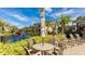 Inviting poolside seating includes a table and chairs with a view of the canal and townhomes at 8043 St Simons St, Bradenton, FL 34201