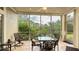 Screened in porch with tile flooring and outdoor dining table and chairs with green view at 8043 St Simons St, Bradenton, FL 34201