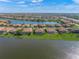 Aerial view of the property backing onto a lake and the surrounding neighborhood at 8294 Barton Farms Blvd, Sarasota, FL 34240