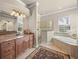 Elegant bathroom with a double vanity, granite countertops, soaking tub, and a separate shower at 8294 Barton Farms Blvd, Sarasota, FL 34240