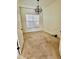 Bedroom featuring neutral carpet, a modern light fixture, and a window with privacy blinds at 8294 Barton Farms Blvd, Sarasota, FL 34240
