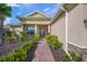 Welcoming home exterior with landscaped pathway, mature plantings, and a charming entranceway at 8294 Barton Farms Blvd, Sarasota, FL 34240