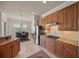 Open kitchen boasts granite countertops, stainless steel appliances, and wood cabinets with backyard view at 8294 Barton Farms Blvd, Sarasota, FL 34240