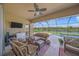 Relaxing screened lanai with comfortable seating, ceiling fan, and a beautiful waterfront view at 8294 Barton Farms Blvd, Sarasota, FL 34240