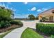 A scenic view of the pool area with lush landscaping, a shaded lanai, and serene water views at 8294 Barton Farms Blvd, Sarasota, FL 34240