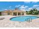 Community pool featuring lounge chairs and a covered lanai area for residents at 8294 Barton Farms Blvd, Sarasota, FL 34240