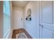 Bright entryway with wood floors, decorative mirror, and coat closet at 9007 Royal River Cir, Parrish, FL 34219