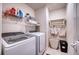 Efficient laundry room featuring a washer, dryer, shelving, and a drying rack for convenience at 9007 Royal River Cir, Parrish, FL 34219