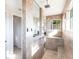 Luxurious bathroom featuring a glass-enclosed shower with seating and a rainfall showerhead at 9332 Miami Cir, Port Charlotte, FL 33981