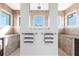 Elegant bathroom showcasing a walk-in shower, double vanity, and natural light at 9332 Miami Cir, Port Charlotte, FL 33981
