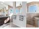 Spacious bathroom with tile flooring, granite countertops, and a glass-enclosed shower at 9332 Miami Cir, Port Charlotte, FL 33981