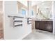 Spa-like bathroom featuring tile flooring, a double vanity, and a walk-in shower at 9332 Miami Cir, Port Charlotte, FL 33981