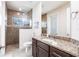 A luxurious bathroom featuring tile flooring, granite countertops, and a glass enclosed shower at 9332 Miami Cir, Port Charlotte, FL 33981