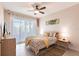 Cozy bedroom featuring tile floors, neutral walls, and natural light at 9332 Miami Cir, Port Charlotte, FL 33981